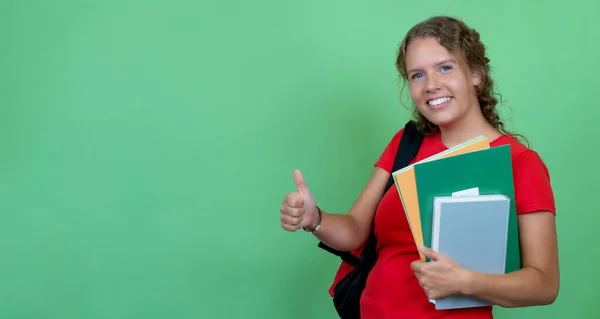 German Female Student Red Shirt Showing Thumb Isolated Green Background — Stock Photo, Image