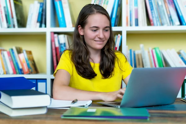Smiling German Female Student Learning Book Computer Desk Indoors Home — Stock Photo, Image