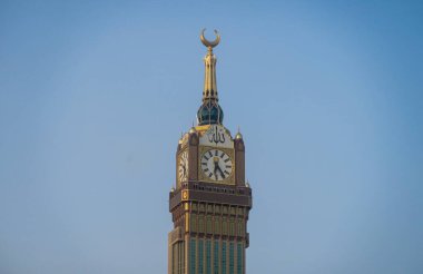 MECCA, SAUDI ARABIA - 21 MAY 2019 Zam-zam Tower or Clock Tower is the tallest clock tower in the world. Abraj Al Bait outside of Masjidil Haram, a holiest mosque for muslim. A landmark of Mecca clipart