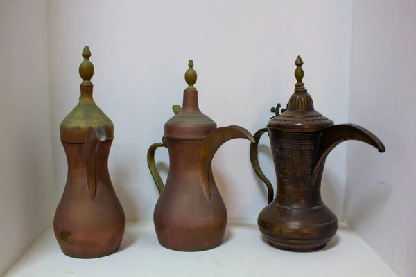 Arab traditional old antique items. Brass coffee pot,cups,plates and trays.