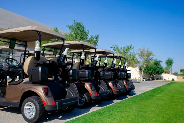 Background image of Golf carts parked on a golf closure in a line.Golf course