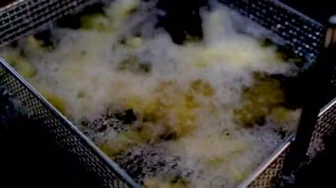 French fries in the deep fryer, in a fast food restaurant. crispy potato fries