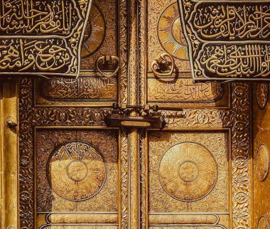 MECCA, SAUDI ARABIA - MARCH 29, 2019 The door of the Kaaba called Multazam at Grant holy mosque Al-Haram in Mecca Saudi Arabia. Muslim Pilgrims at The Kaaba in The Great Mosque of Mecca.