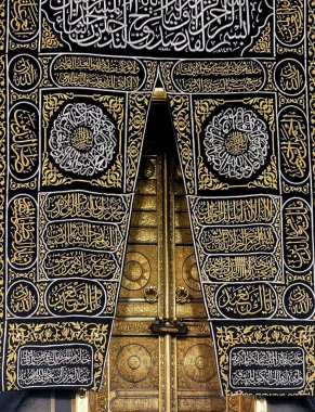 MECCA, SAUDI ARABIA - MARCH 29, 2019 The door of the Kaaba called Multazam at Grant holy mosque Al-Haram in Mecca Saudi Arabia. Muslim Pilgrims at The Kaaba in The Great Mosque of Mecca.