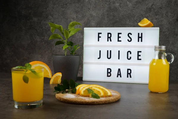 Fresh juice bar concept. Oranges with fresh orange juice