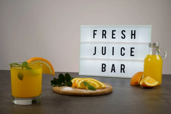 Fresh juice bar concept. Oranges with fresh orange juice
