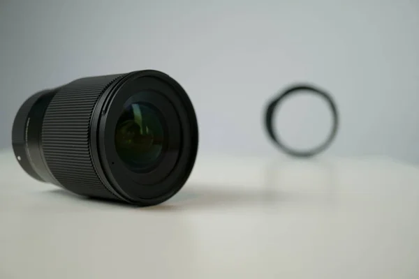 Dslr camera lense, close-up view on table with smooth background — Stock Photo, Image