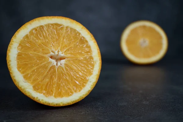 Fresh sliced oranges and on gray background — Stock Photo, Image