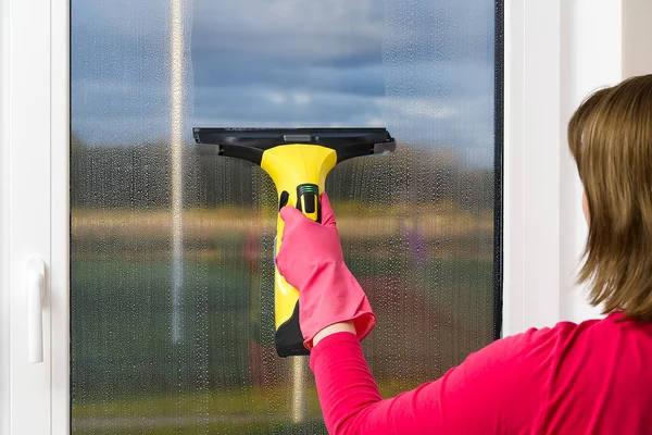 Attractive wife washing a window. Gloved hand cleaning window rag and spray. washing windows. cleaning service concept. — Stock Photo, Image