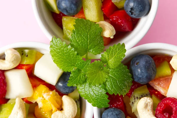 新鲜水果沙拉放在白碗上.混合水果在白碗健康的食物风格。有益的水果色拉新鲜水果和浆果粉红背景.三碗水果沙拉 — 图库照片