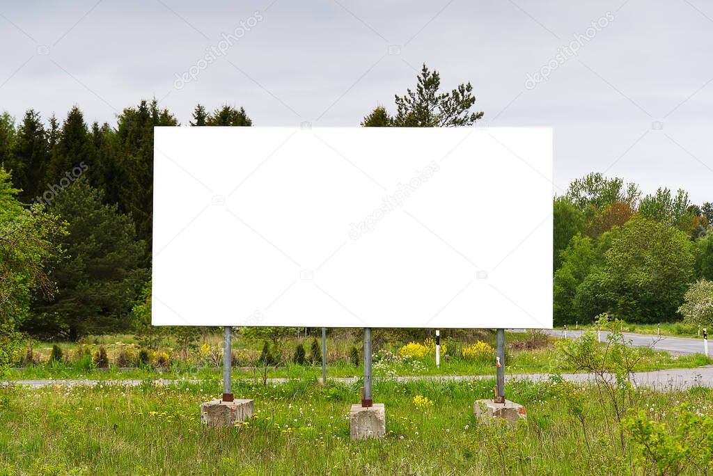 billboard on a background of green nature. suitable for advertising. Blank billboard and outdoor advertising. Mockup poster outside.