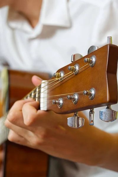 Young boy playing guitar. Close-up of man hand playing classic guitar. teenager learning playing guitar.