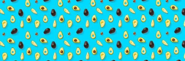 Avocado banner. Background made from isolated Avocado pieces on blue background. Flat lay of fresh ripe avocados and avacado pieces