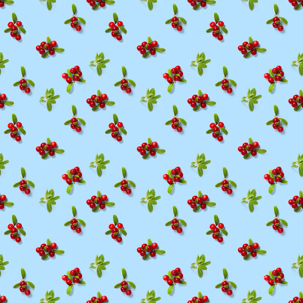Lingonberry seamless pattern on blue background. Fresh cowberries or cranberries with leaves as seamless pattern for textile, fabric, print or posters