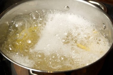 Kavanozda makarna kaynatmak. Penne rigate hamur işi. Kaynar suda makarna pişirmek. Kapat. Çataldaki makarna kalitesine bakıyorum.