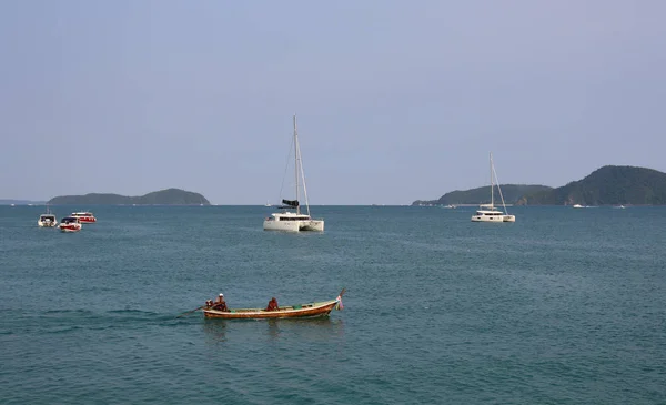 view of the sea, boats of fishermen, boats and yachts on the background of tropical islands
