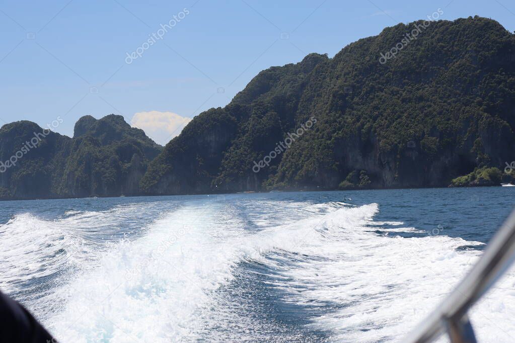 background waves and splashes, speedboat ride near tropical islands in ocean in asia