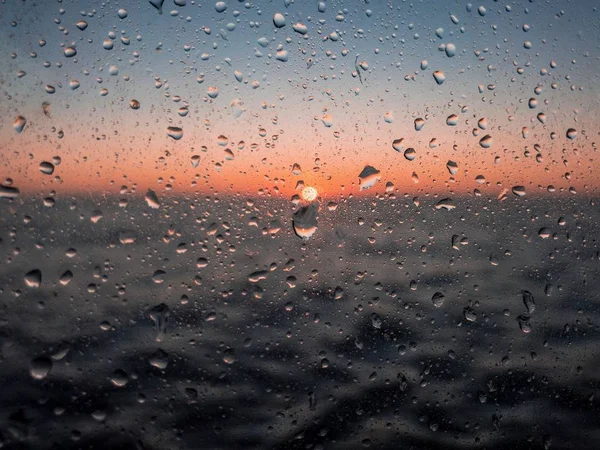 raindrops on the glass against the sunset