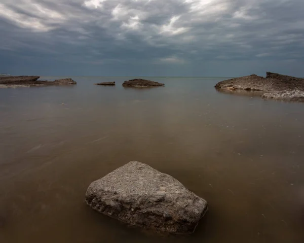 Stone in the murky waters, Lake Erie Ohio — Stock Photo, Image