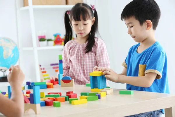 Asian preschool student build block toys at home or daycare. Ch
