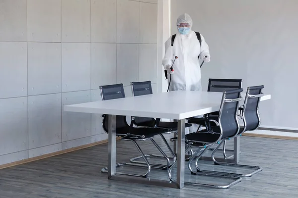 Cleaning and Disinfection at meeting room amid the coronavirus epidemic Professional teams for disinfection efforts Infection prevention and control of epidemic Protective suit and mask.