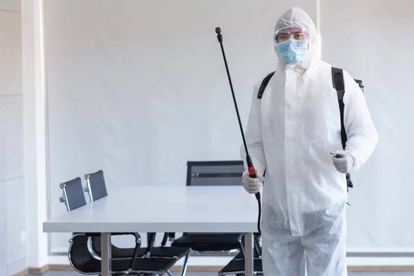 Cleaning and Disinfection at meeting room amid the coronavirus epidemic Professional teams for disinfection efforts Infection prevention and control of epidemic Protective suit and mask.