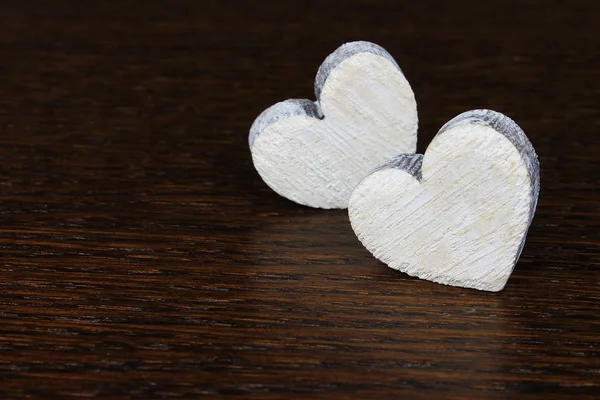 Decoratieve houten harten op donkere houten achtergrond — Stockfoto