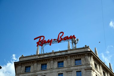 Milan, Italy  07.06.2019: A huge, red Ray-Ban logo on the top of a building in Milano 