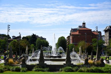 Milano, Italy, 14.07.2019: Fountain of The Four Seasons, Fontana delle Quattro Stagioni at Julius Caesar Square, Piazzale Giulio Cesare next to City Life and  Tre Torri shopping and business districts clipart