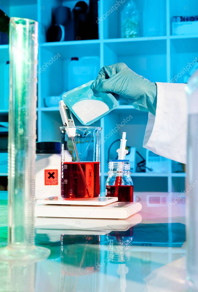 Scientist or tech makes buffer solution in the lab