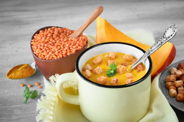 Tasty pumpkin cream soup served with croutons in light yellow mu — Stock Image Tasty pumpkin cream soup served with croutons in light yellow mu Royalty Free Stock Photos