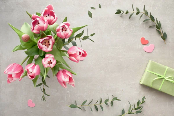 Springtime flat lay with bunch of pink tulips, eucalyptus leaves — Stock Photo, Image