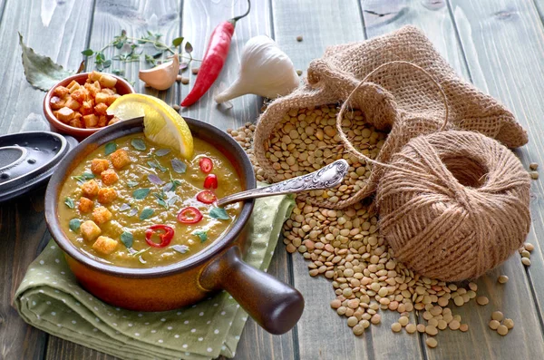 Spicy lentil soup with chili, garlic and onion on wooden table — Stock Image Spicy lentil soup with chili, garlic and onion on wooden table Stock Picture