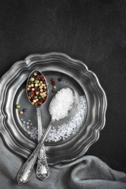 L ile eski metal plaka üzerinde vintage kaşık karışık biber tuz