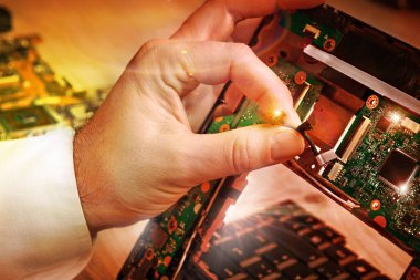Teknik servis merkezinde dizüstü bilgisayarı tamir ediyor.