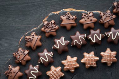 Koyu dokulu arka planda yıldız şeklinde çikolatalar