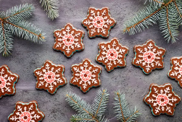 Snowflake chocolates with colorful icing on dark textured backgr — Stock Photo, Image