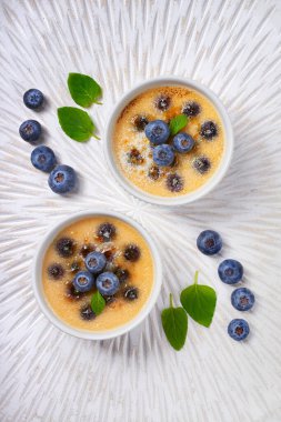Creme brulee (cream brulee, burnt cream) with blueberry and lave
