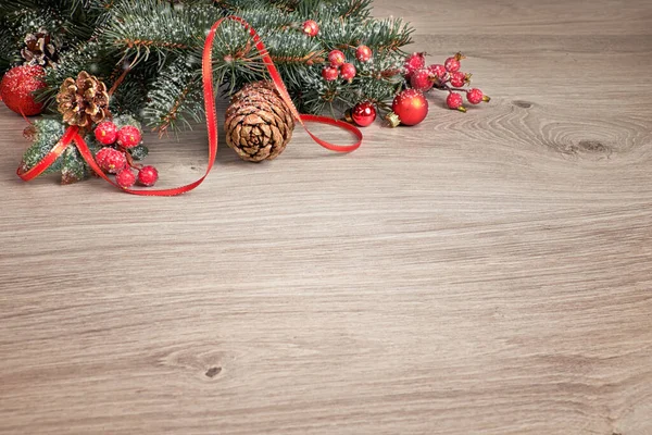 Wooden background with decorated Christmas tree twigs — Stock Photo, Image
