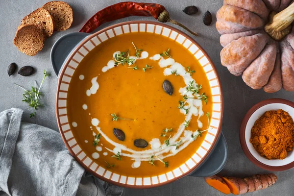Pumpkin creme soup in ceramic bowl seasoned with thyme, cream an — Stock Photo, Image
