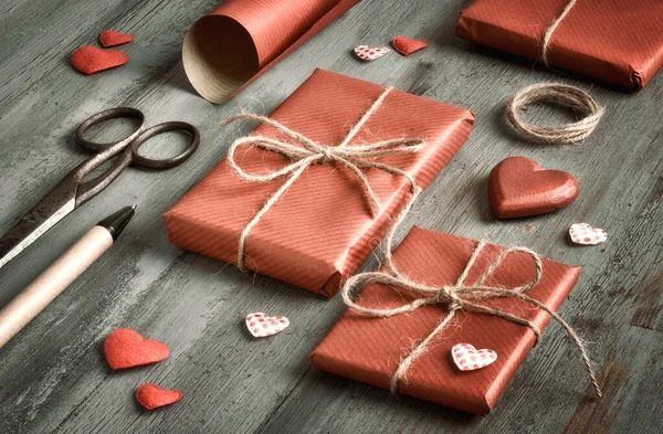 Packed Presents Wrapped Red Paper Decorative Hearts Cissors Pen Writing — Stock Photo, Image