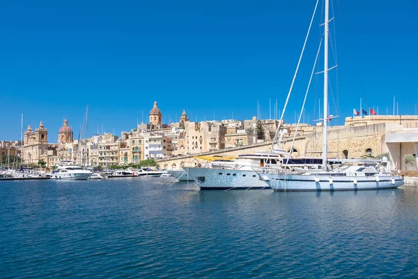Sailing boats on Senglea marina in Grand Bay, Valetta, Malta, on a bright sunny morning