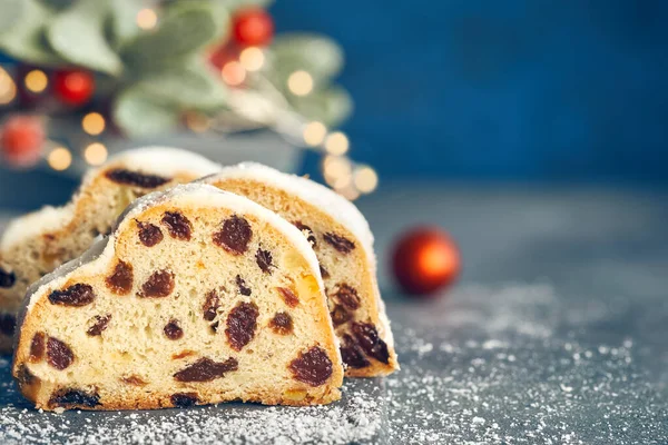 Christmas stollen on blue-green festive background with Xmas lig — Stock Photo, Image