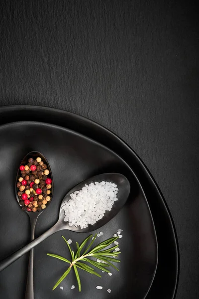 Salt in mixed pepper in vintage spoons on old metal plate with l — Stock Photo, Image