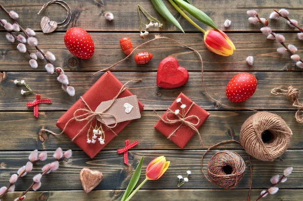 Overhead view of wooden table with springtime decorations, wrapp — ストック写真