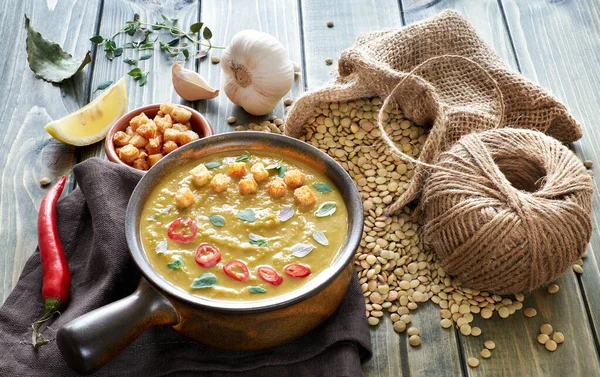 Spicy lentil soup with chili, garlic and onion on wooden table — Stock Image Spicy lentil soup with chili, garlic and onion on wooden table Stock Image