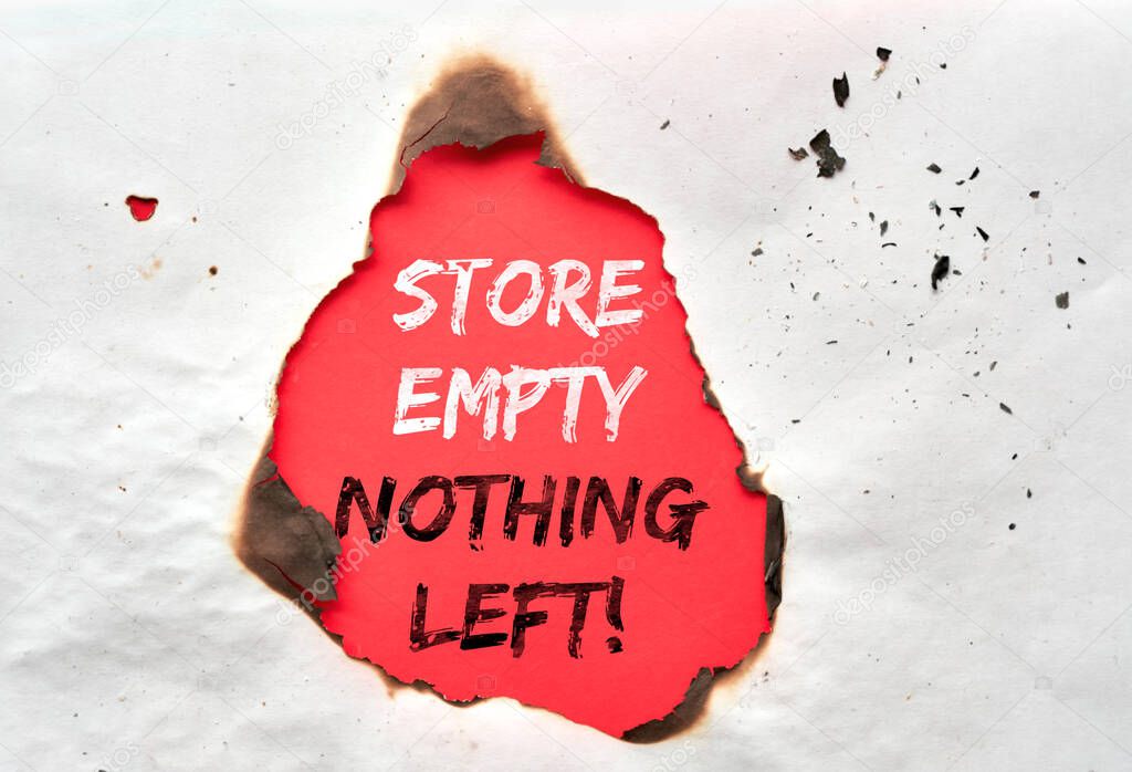 Paper hole with burned edges, text Store Empty Nothing Left on red paper in the hole. Boutique shops, stores looted, owners in despair. Aftermath concept. Protests, riots and looting in New York City.