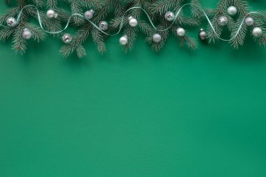 Yeşil tekstil masa örtüsü üzerine dekoratif Noel sınırı, fotokopi alanı. Doğal köknar dalları Xmas mücevherleri, ayna disko topları, kurdele.