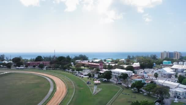 Aerial drone camera approaching a tent near Garrison Savannah racecourse in Bridgetown, Barbados — Stock Video