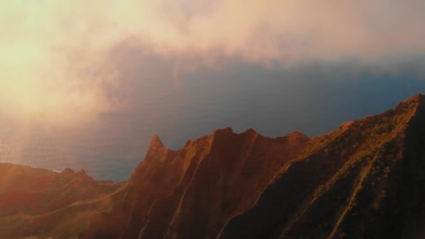 A drónkamera a napsütötte óceánra és az arany hegycsúcsokra néz a Waimea kanyonban, Kauaiban, Hawaiin. — Stock videók